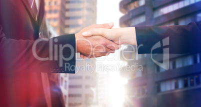 Composite image of executives shaking hands