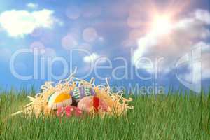 Composite image of patterned easter eggs in paper nest