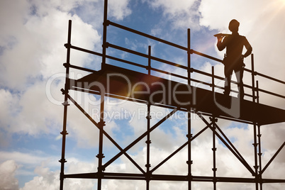 Composite image of thoughtful worker carrying wooden planks