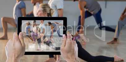 Composite image of cropped hand holding digital tablet