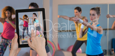 Composite image of hands touching digital tablet against white background