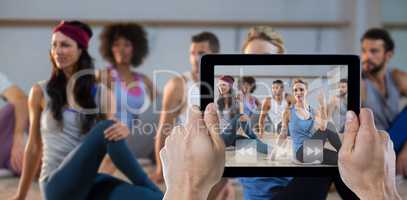 Composite image of cropped hand holding digital tablet