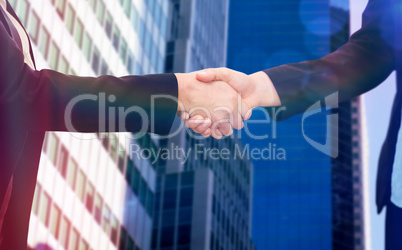 Composite image of businessman shaking hands with colleague