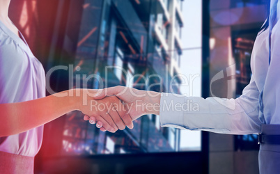 Composite image of businesswomen shaking hands