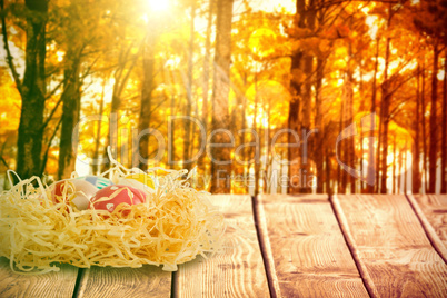 Composite image of easter eggs in creative paper nest