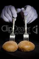 Buns on the forks and hands in white gloves
