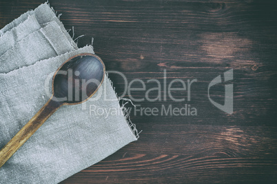 Old wooden spoon on a gray napkin