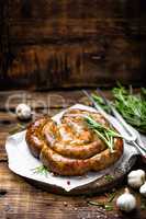 Grilled sausage on dark rustic wooden background