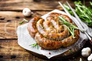 Grilled sausage on dark rustic wooden background