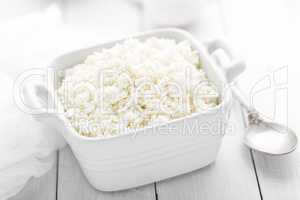 Cottage cheese on white wooden rustic background, dairy product