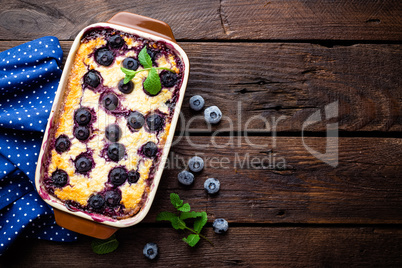 Blueberry cheesecake on dark wooden rustic backgroud, top view