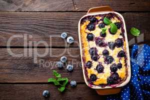 Blueberry cheesecake on dark wooden rustic backgroud, top view