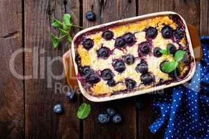 Blueberry cheesecake on dark wooden rustic backgroud, top view