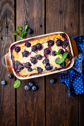 Blueberry cheesecake on dark wooden rustic backgroud, top view