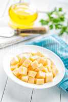 Cheese slices on plate, white background