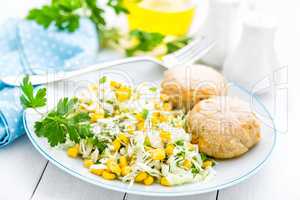 Vegetable cabbage salad and meatballs on plate close up, white background