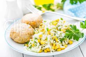 Vegetable cabbage salad and meatballs on plate close up, white background