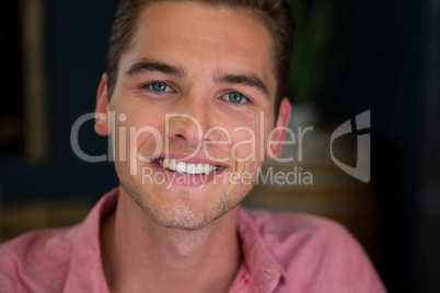 Smiling young man in coffee shop