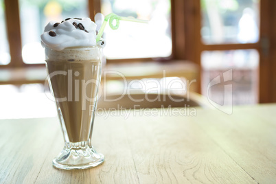 Glass of chocolate milkshake with cream