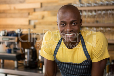 Smiling male barista in coffee shop