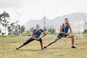 Fit man and woman exercising in boot camp