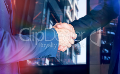 Composite image of male executives shaking hands