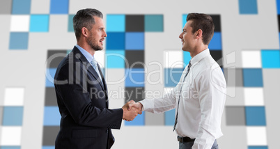 Composite image of smiling businessmen shaking hands