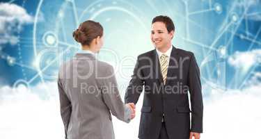 Composite image of smiling businessman shaking hands with colleague
