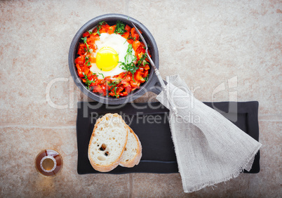 Traditional middle eastern dish of shakshuka in a pan .