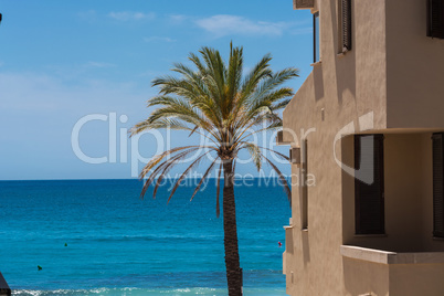 Overlooking the blue sea in the foreground a house