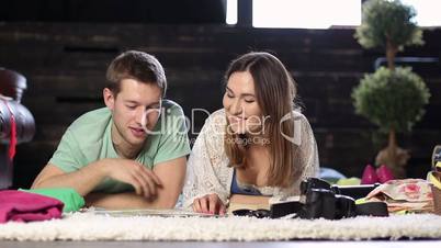 Young couple planning romantic adventure with map