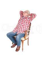 Senior man relaxing on chair.