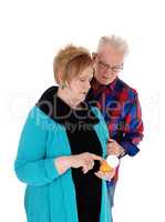 Wife showing husband his pills.