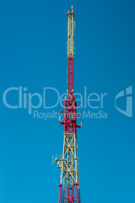Peak of a telecommunications tower against the blue sky