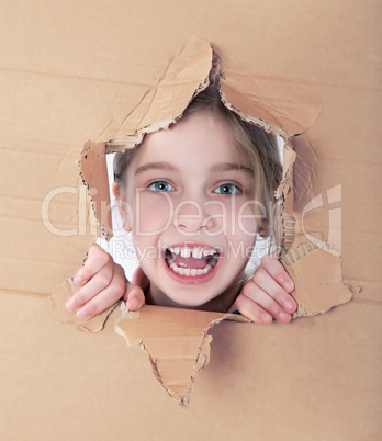 kid portrait in torn paper hole