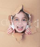 kid portrait in torn paper hole