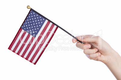 Hand holding american flag on white