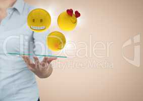 Business woman mid section with tablet and emojis and flares against cream background