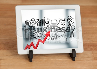 Tablet on stand showing red arrow with black business doodles against blurry background