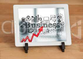 Tablet on stand showing red arrow with black business doodles against blurry background