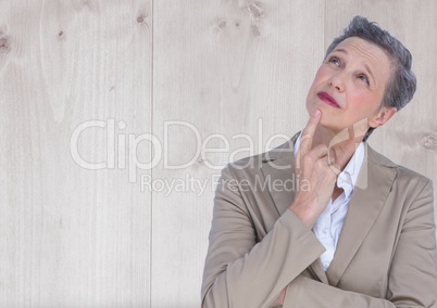 Older Businesswoman thinking against wood