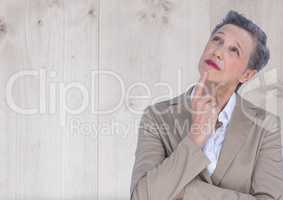 Older Businesswoman thinking against wood