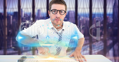 Digital composite image of businessman touching futuristic desk with icons on screen
