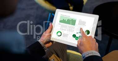 Businessman analyzing graphs on digital tablet