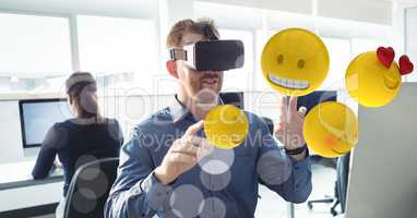 Businessman touching various emojis seen through VR glasses in office