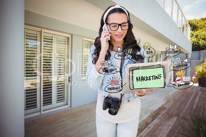 Digitally generated image of woman using mobile phone and laptop with marketing diagram