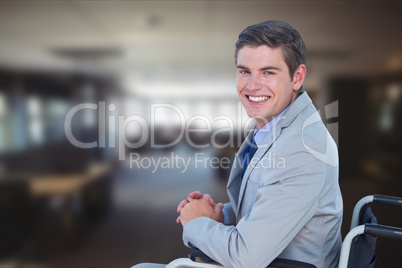 Portrait of businessman sitting on wheelchair in office