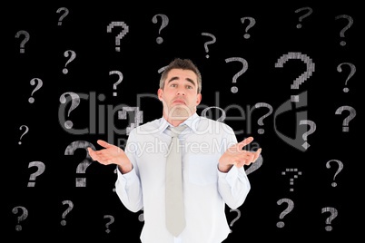 Confused businessman with question mark signs