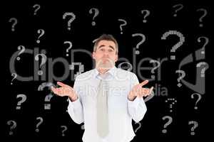 Confused businessman with question mark signs