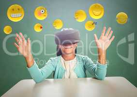 Kid in VR beneath emojis against green chalkboard